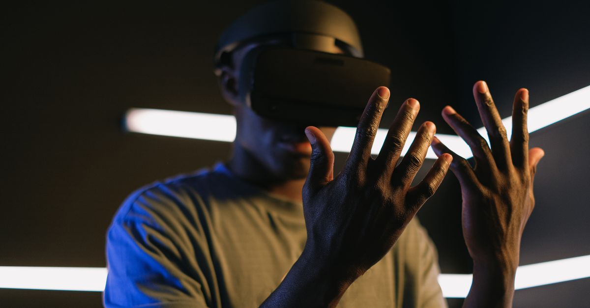 Focused view of a person using VR goggles and exploring virtual reality. Captures modern technology theme.